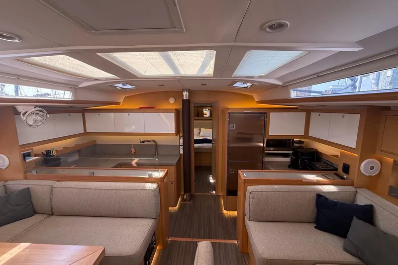 Tupelo Honey Yacht Photos Pics Luxurious interior of 2022 Dufour 530 yacht with modern kitchen and seating area.