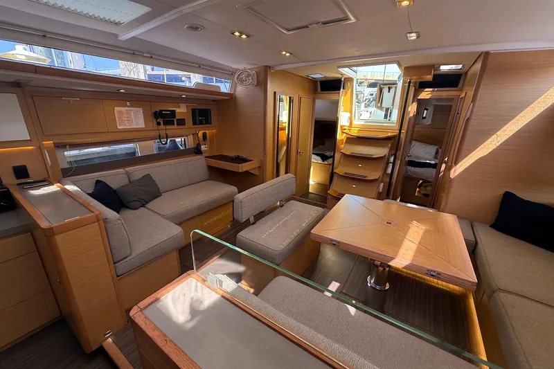 Tupelo Honey Yacht Photos Pics Luxurious interior of 2022 Dufour 530 yacht with modern furnishings and ample natural light.