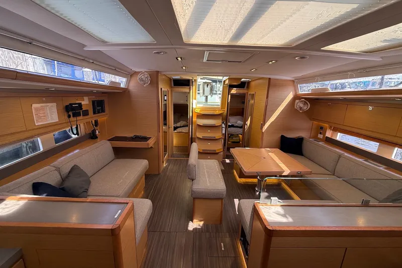 Tupelo Honey Yacht Photos Pics Luxurious interior of 2022 Dufour 530 yacht with modern furnishings and ample natural light.