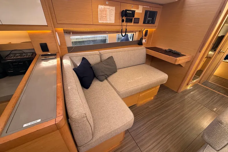 Tupelo Honey Yacht Photos Pics Modern interior of 2022 Dufour 530 yacht with cozy seating and wooden finishes.
