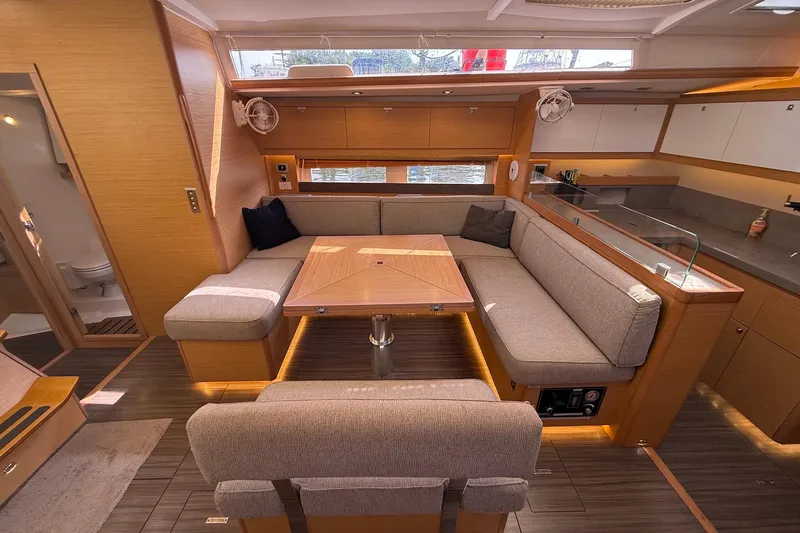 Tupelo Honey Yacht Photos Pics Luxurious interior of 2022 Dufour 530 yacht with modern seating and dining area.