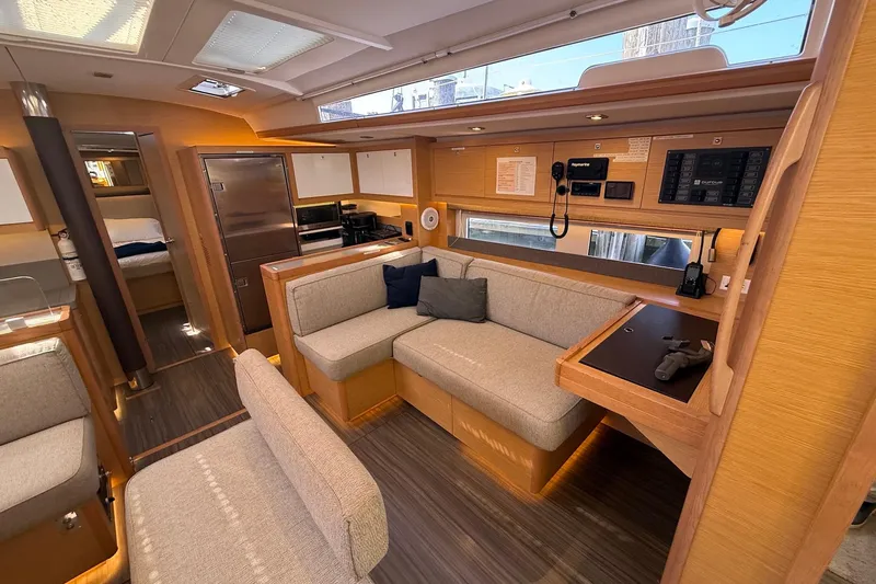 Tupelo Honey Yacht Photos Pics Luxurious interior of 2022 Dufour 530 yacht with modern seating and navigation equipment.