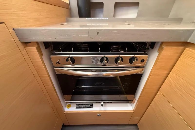 Tupelo Honey Yacht Photos Pics Modern kitchen stove in 2022 Dufour 530 yacht, featuring sleek stainless steel design.
