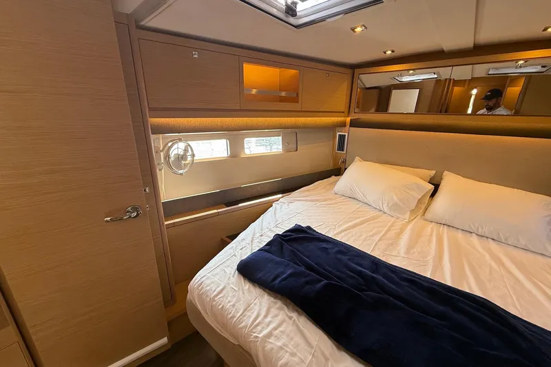 Tupelo Honey Yacht Photos Pics Luxurious cabin interior of 2022 Dufour 530 yacht with cozy bedding and modern design.