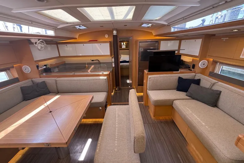 Tupelo Honey Yacht Photos Pics Luxurious interior of 2022 Dufour 530 yacht with modern seating and dining area.