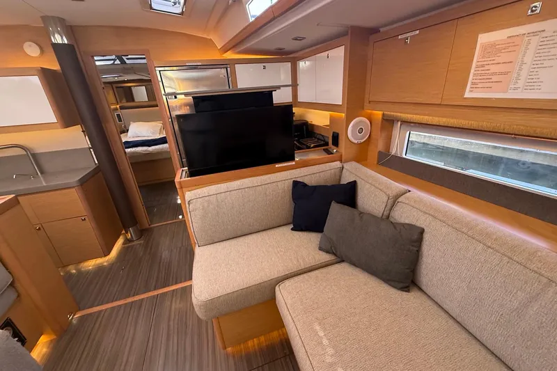 Tupelo Honey Yacht Photos Pics Luxurious interior of 2022 Dufour 530 yacht with modern furnishings and cozy seating area.