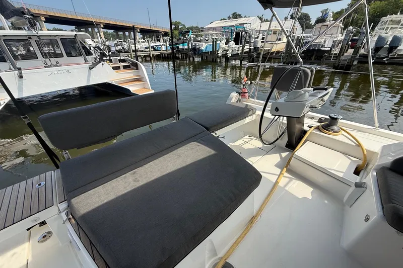 Tupelo Honey Yacht Photos Pics 2022 Dufour 530 yacht cockpit with seating and steering wheel, docked at marina.