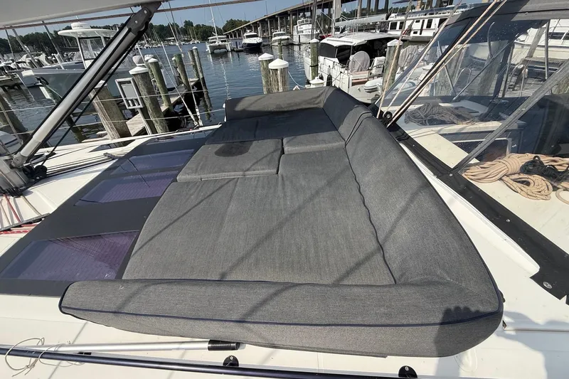 Tupelo Honey Yacht Photos Pics 2022 Dufour 530 yacht with spacious sunbathing area, docked at marina.