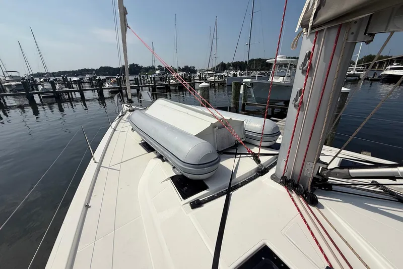 Tupelo Honey Yacht Photos Pics 2022 Dufour 530 sailboat deck with lifeboats, docked at a marina.