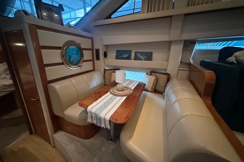 Stay The Course Yacht Photos Pics Interior of 2006 Carver 43 Motor Yacht with cozy dining area and nautical decor.