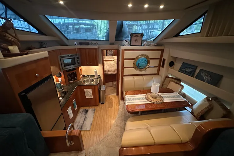 Stay The Course Yacht Photos Pics Luxurious interior of 2006 Carver 43 Motor Yacht with kitchen and dining area.
