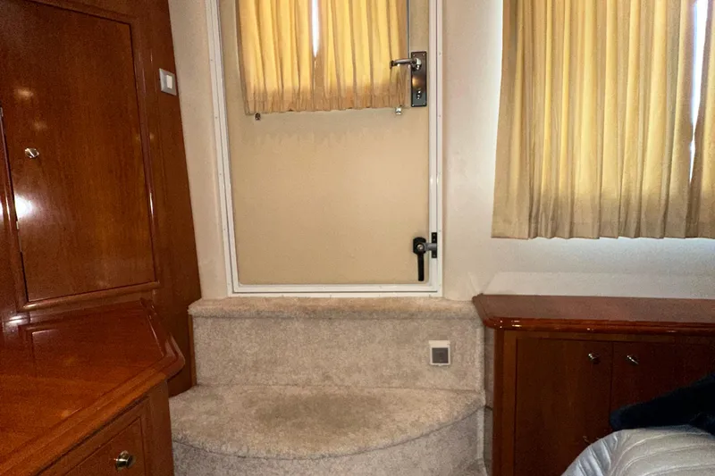 Stay The Course Yacht Photos Pics Interior of 2006 Carver 43 Motor Yacht with wooden cabinetry and carpeted steps.