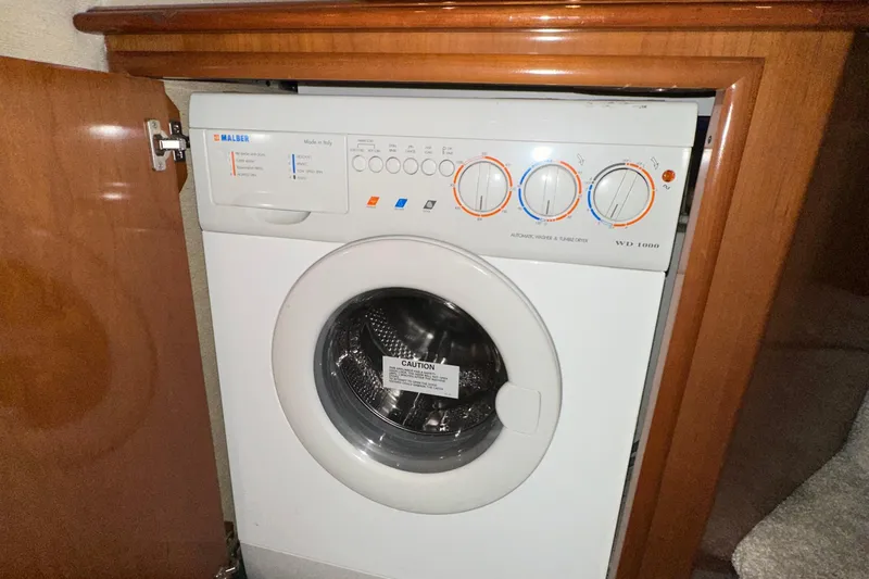 Stay The Course Yacht Photos Pics Washer-dryer unit inside 2006 Carver 43 Motor Yacht, wooden cabinetry.
