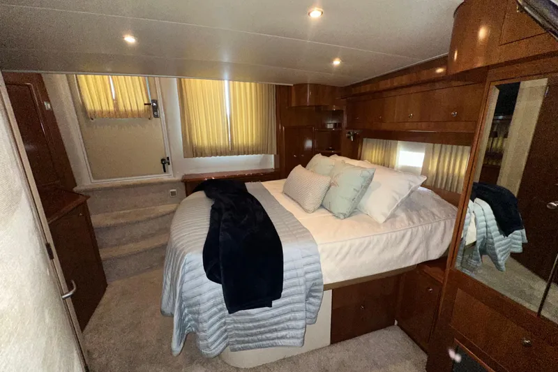 Stay The Course Yacht Photos Pics Luxurious bedroom interior of 2006 Carver 43 Motor Yacht with elegant wood finishes.