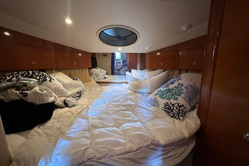 Stay The Course Yacht Photos Pics Cozy bedroom interior of 2006 Carver 43 Motor Yacht with plush bedding and wooden cabinets.