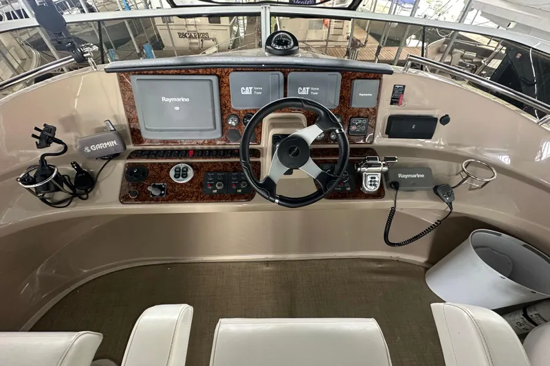 Stay The Course Yacht Photos Pics 2006 Carver 43 Motor Yacht helm with Raymarine and Garmin navigation systems.