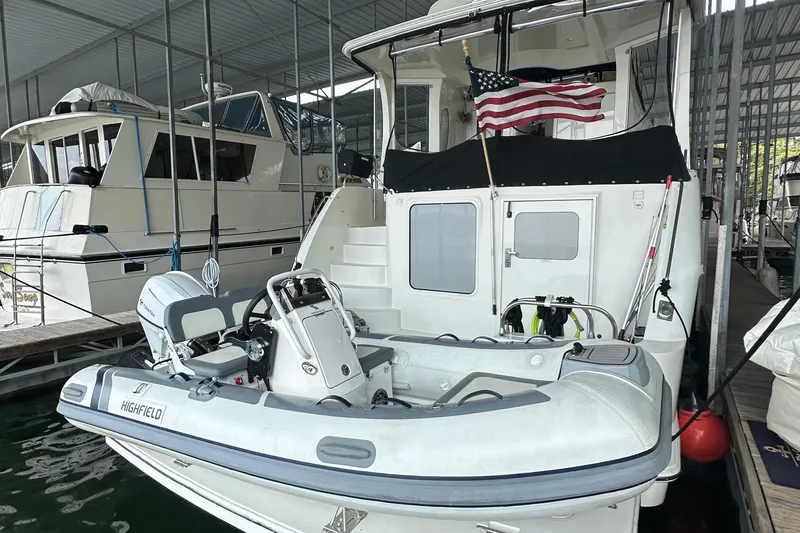 Stay The Course Yacht Photos Pics 2006 Carver 43 Motor Yacht docked with inflatable boat and American flag.