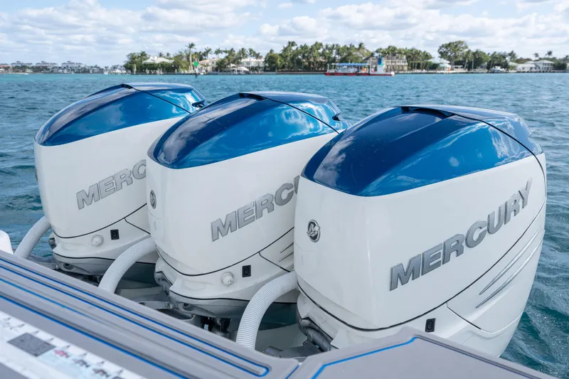 Boss's Therapy Yacht Photos Pics Triple Mercury outboard engines on a 2007 Intrepid 375 Center Console boat, cruising on blue waters.
