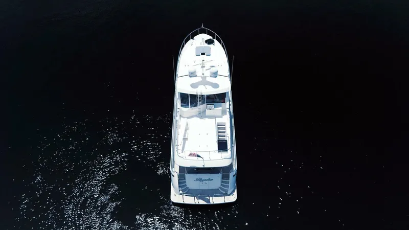 Psyche Yacht Photos Pics Aerial view of 2015 Ocean Alexander 72 yacht on dark water.