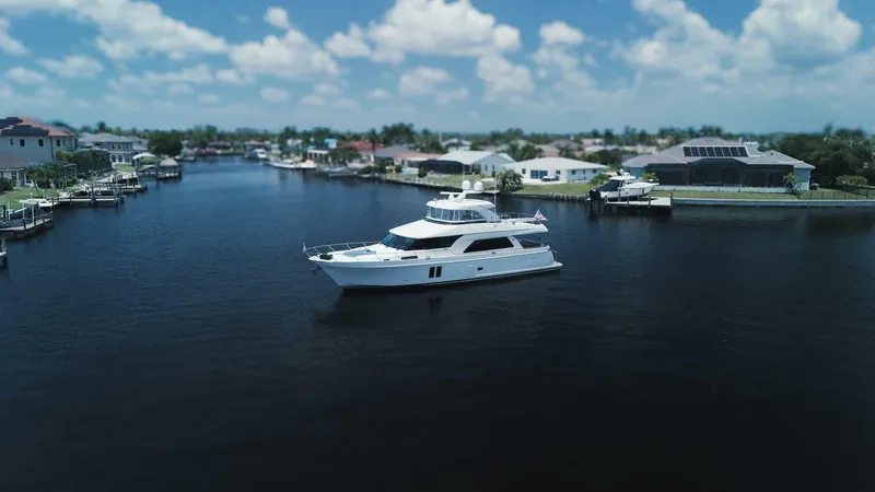 Psyche Yacht Photos Pics Luxurious 2015 Ocean Alexander 72 yacht cruising in a serene residential canal.