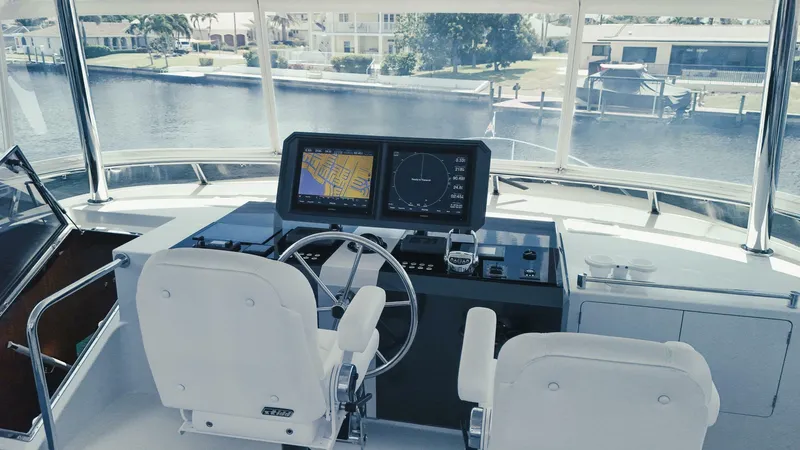 Psyche Yacht Photos Pics Helm of 2015 Ocean Alexander 72 yacht with navigation screens and steering wheel.