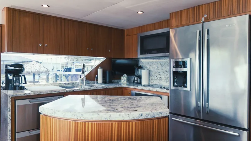 Psyche Yacht Photos Pics Luxurious kitchen interior of 2015 Ocean Alexander 72 yacht with modern appliances and granite countertops.