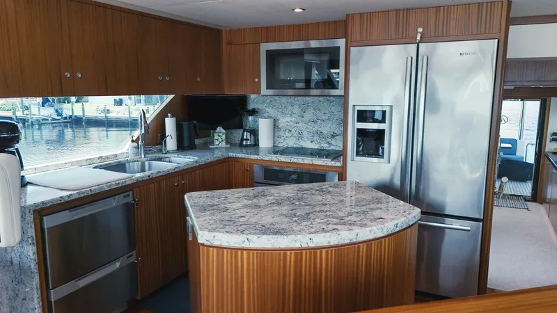 Psyche Yacht Photos Pics Luxurious kitchen interior of 2015 Ocean Alexander 72 yacht with modern appliances and granite countertops.