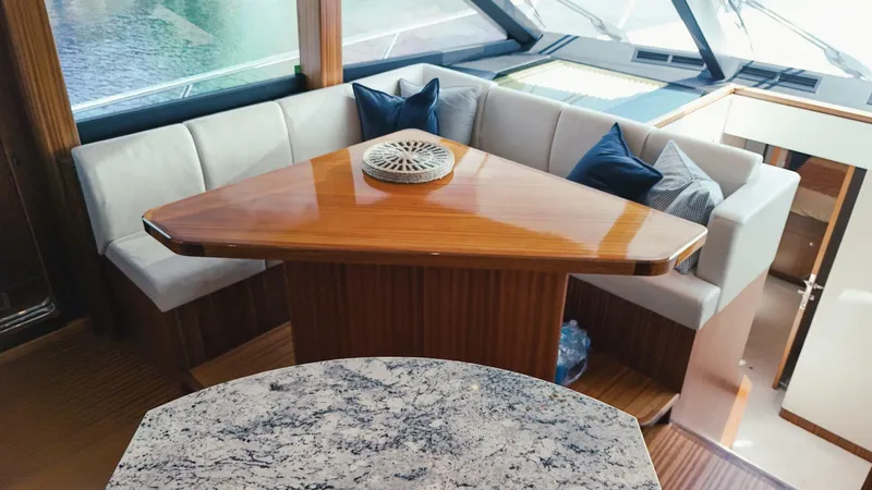 Psyche Yacht Photos Pics Luxurious interior of 2015 Ocean Alexander 72 yacht with elegant seating and wooden table.
