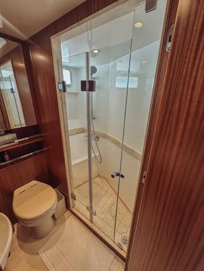 Psyche Yacht Photos Pics Luxurious bathroom in 2015 Ocean Alexander 72 yacht with glass shower and wooden accents.