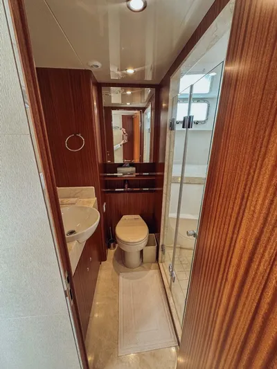 Psyche Yacht Photos Pics Luxurious bathroom in 2015 Ocean Alexander 72 yacht with wood accents and modern fixtures.