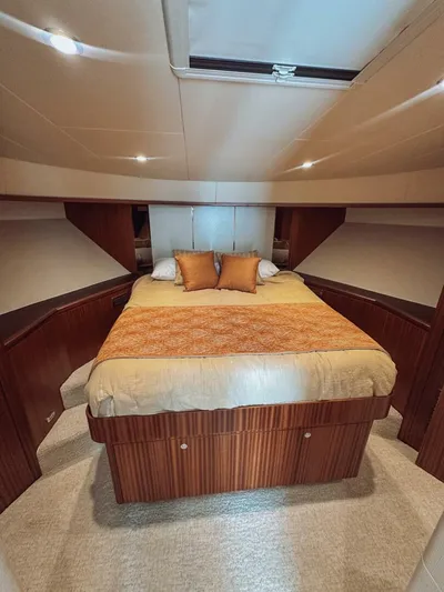 Psyche Yacht Photos Pics Luxurious bedroom interior of 2015 Ocean Alexander 72 yacht with elegant bedding and wood accents.