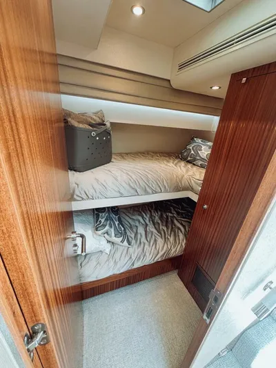 Psyche Yacht Photos Pics Bunk beds in 2015 Ocean Alexander 72 yacht cabin with wood paneling and cozy bedding.