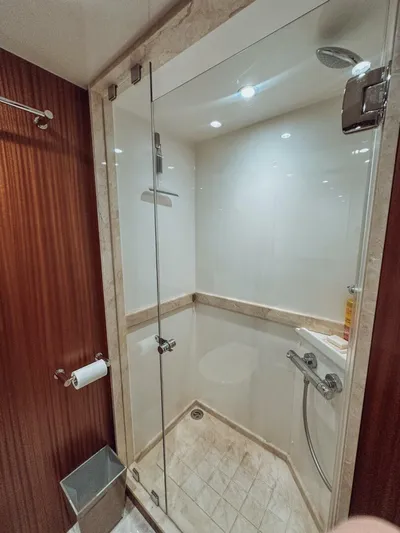 Psyche Yacht Photos Pics Luxurious shower in 2015 Ocean Alexander 72 yacht, featuring glass door and elegant wood paneling.
