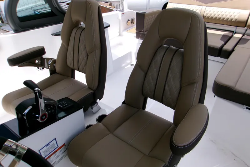  Yacht Photos Pics Luxurious seating in 2026 Monterey Elite 27 OB boat interior, featuring premium upholstery and controls.