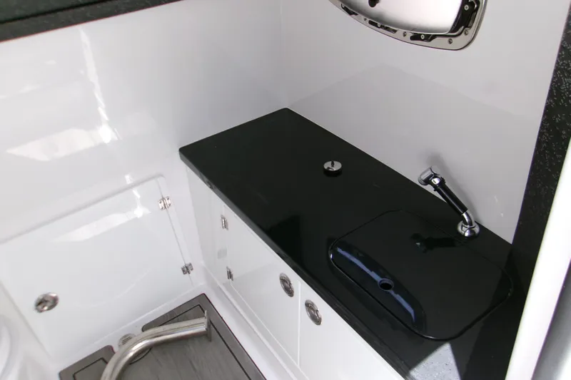  Yacht Photos Pics Interior of 2026 Monterey Elite 27 OB boat featuring sleek black countertop and modern fixtures.