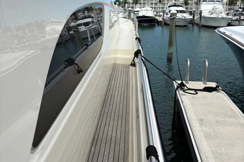 Rabbit Yacht Photos Pics 1999 Ferretti Yachts 80 RPH docked, showcasing sleek design and wooden deck.