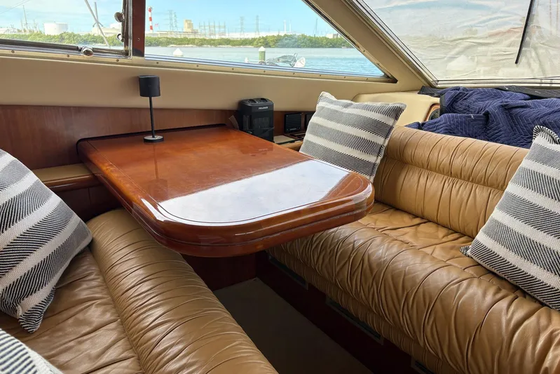 Rabbit Yacht Photos Pics Luxurious interior of 1999 Ferretti Yachts 80 RPH with leather seating and wooden table.