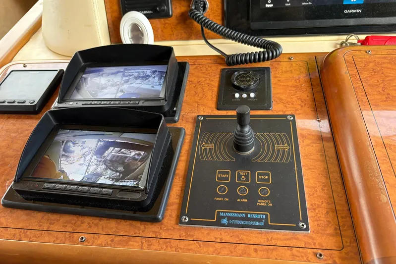 Rabbit Yacht Photos Pics Control panel of a 1999 Ferretti Yachts 80 RPH with monitors and joystick.
