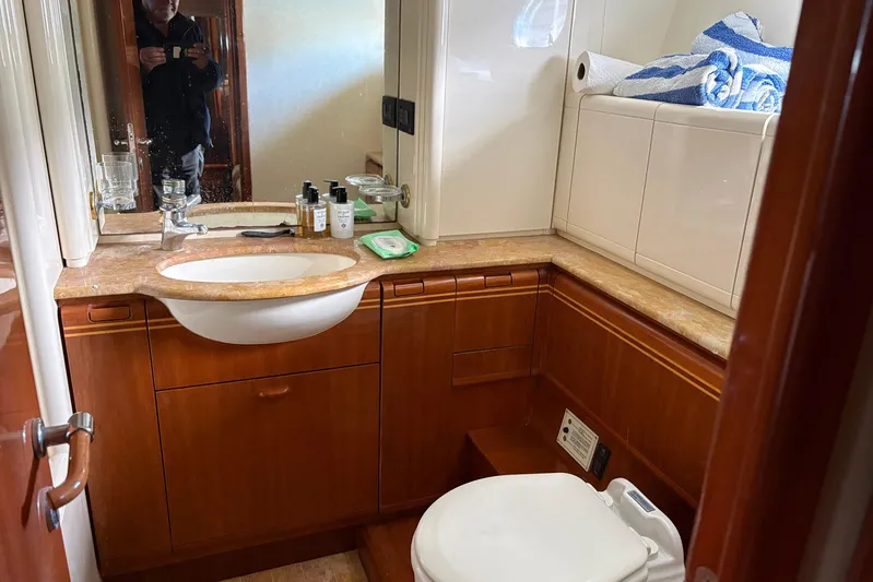 Rabbit Yacht Photos Pics Bathroom interior of 1999 Ferretti Yachts 80 RPH with sink, toiletries, and towels.