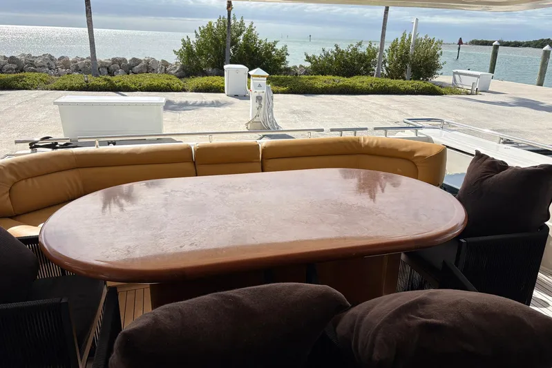 Rabbit Yacht Photos Pics Outdoor seating area on a 1999 Ferretti Yachts 80 RPH, overlooking a scenic waterfront.
