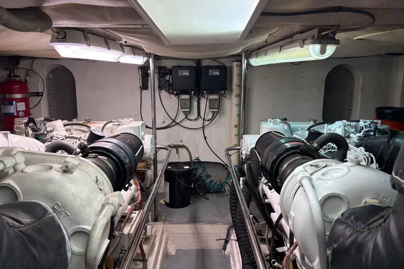 Rabbit Yacht Photos Pics Engine room of a 1999 Ferretti Yachts 80 RPH, featuring dual engines and equipment.