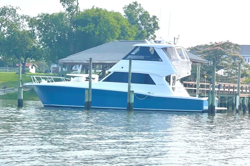  Yacht Photos Pics 1999 Riviera Convertible SF yacht docked by a scenic waterfront.