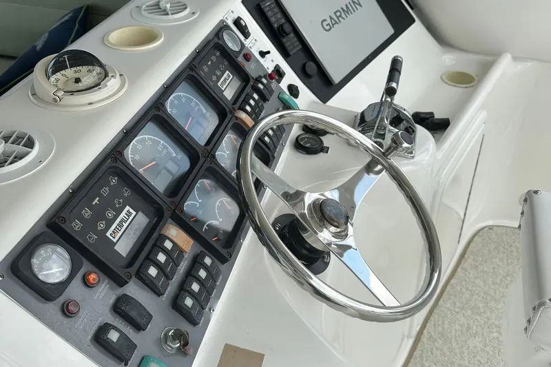  Yacht Photos Pics 1999 Riviera Convertible SF boat dashboard with steering wheel and navigation instruments.