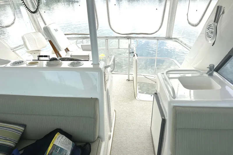  Yacht Photos Pics Interior of 1999 Riviera Convertible SF yacht with seating and sink area.