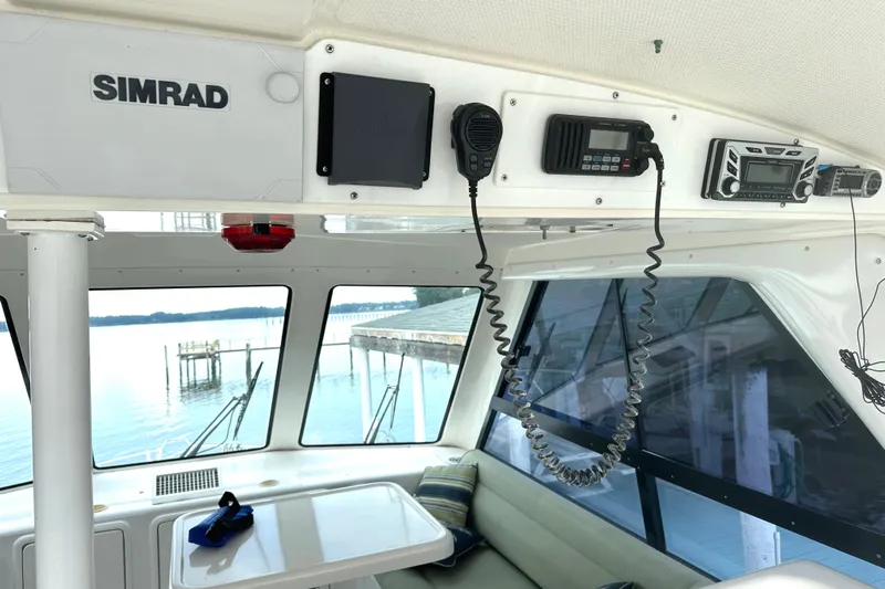  Yacht Photos Pics Interior of 1999 Riviera Convertible SF boat with navigation equipment and waterfront view.