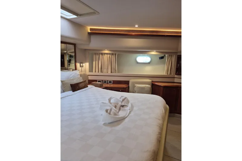  Yacht Photos Pics Luxurious bedroom interior of 2006 Ferretti Yachts 830, featuring elegant bedding and wood accents.