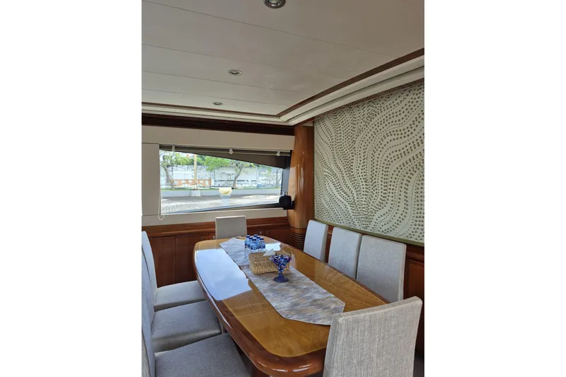  Yacht Photos Pics Luxurious dining area inside a 2006 Ferretti Yachts 830, featuring elegant decor and seating.