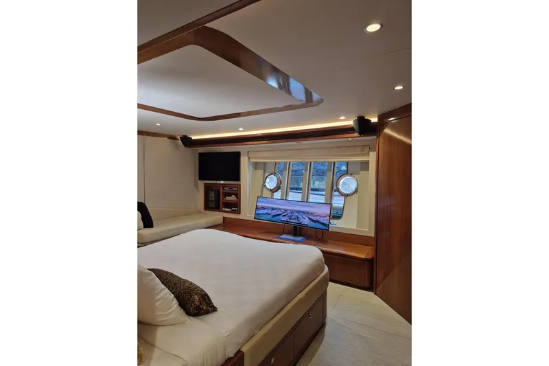  Yacht Photos Pics Luxurious bedroom interior of 2006 Ferretti Yachts 830 with modern amenities and elegant design.