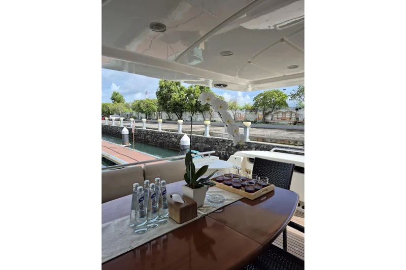  Yacht Photos Pics Luxurious 2006 Ferretti Yachts 830 deck with elegant table setting and scenic marina view.