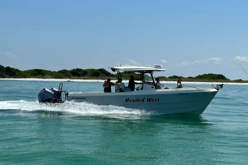  Yacht Photos Pics Eastward 30 boat cruising on clear water near a sandy beach, 2022 model.